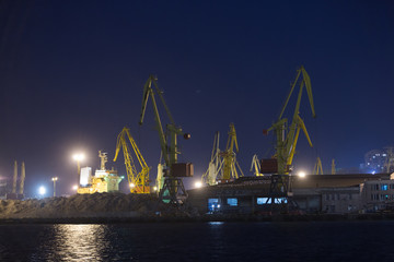 Obraz premium Port terminal of bulk cargo at night time. Industrial port at night