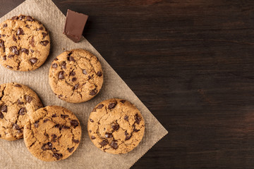 Chocolate chips cookies on baking paper with copyspace - obrazy, fototapety, plakaty