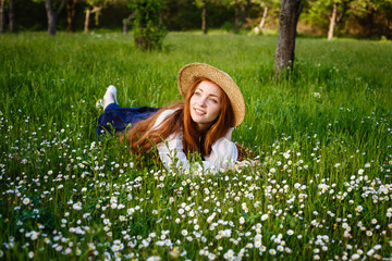 Summer portrait, beautiful freckled young woman wearing straw hat