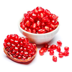 Pomegranate and seeds in ceramic bowl close-up