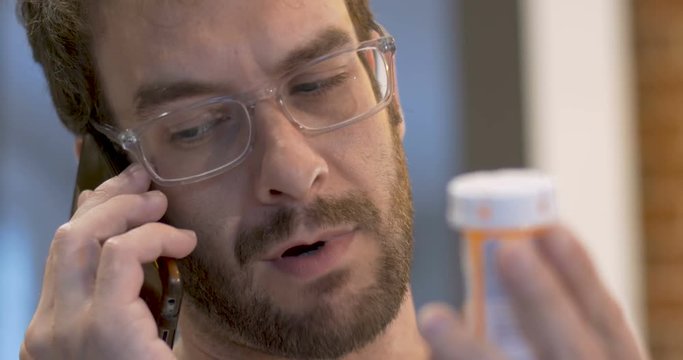 Happy young adult male refilling his prescription on his mobile phone