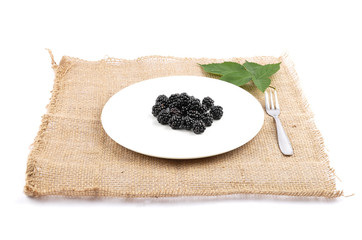Brombeeren auf Teller und Jute
