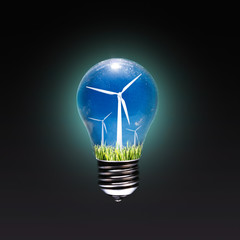 Renewable energy concept. Electric bulb with a windmill inside on a dark background.