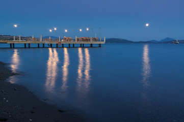 Fototapeta premium Sunset view of restaurant's pier in Ortakent, Mugla province, Turkey.