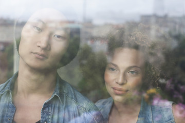 Close-up of couple seen through glass window