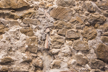 Stone wall background and ancient tuff, Tuscany in Italy
