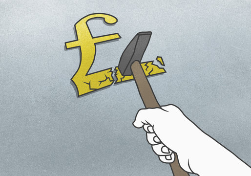 Cropped hand breaking Pound symbol with hammer on gray background