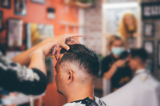 Barber haircut a customer at barbershop