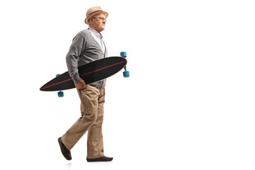 Mature man holding a longboard and walking