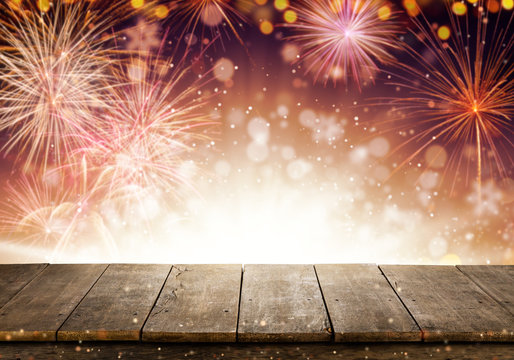 Abstract colored firework background with empty wooden planks, free space for product placement.