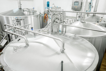 Equipment for the brewery. Large shiny tanks.