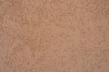 Pale pinkish orange decorative plastered wall texture