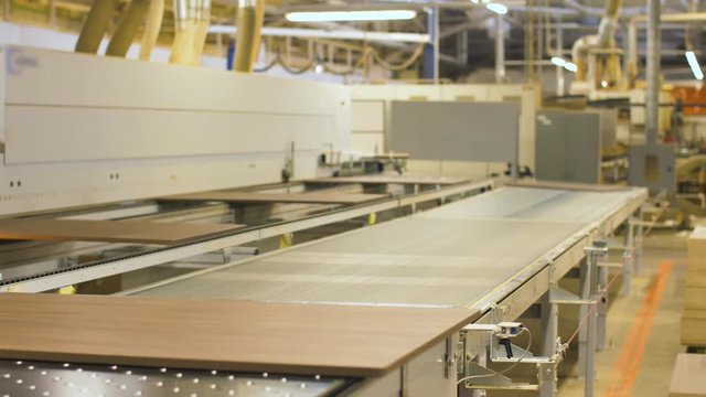 chipboards on conveyer at furniture factory