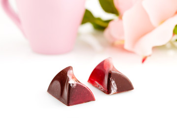 Red colored handmade chocolate candies on white background. Valentines day