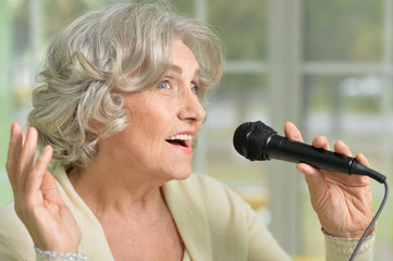 senior woman singing with microphone