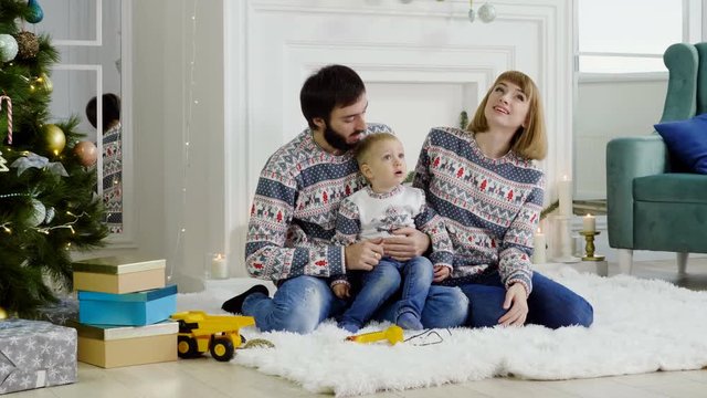 Young mother, father and male child celebrating the Christmas or New Year. 4K