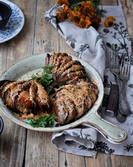 On a dish baked eggplants with cheese and fresh greens
