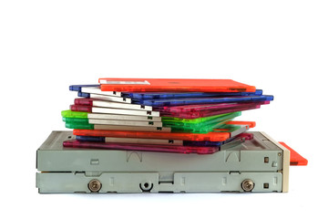 Floppy disk drive and diskettes on white background