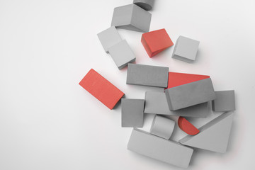 Red and gray toy building blocks on a white background