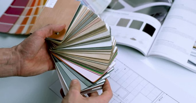 interior designer choosing furniture material from sample palette