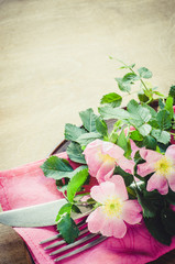 Festive Table setting with pink flowers.