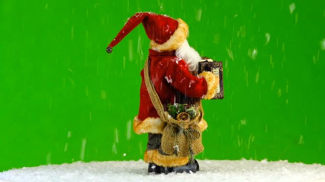 Santa Claus plays a musical instrument on the green screen