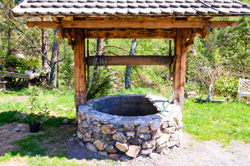 Old stone well of a rustic garden