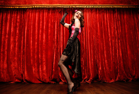 dancer in moulin rouge style is dancing on the stage