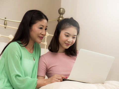 Mother and daughter are using computer