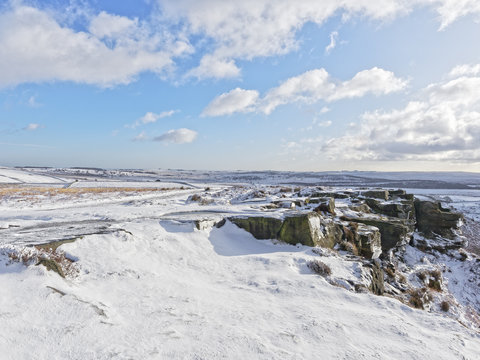 Bright winters day on a snow covered Curbar Edge in the Peak District