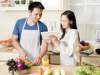 selective focus of Lover preparing vegetables for cooking, husband hold a knife and slice a green vegetables