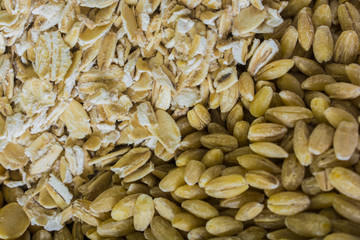 Raw porridge and wheat background