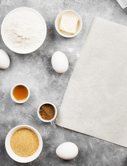 Ingredients for baking of cookies - flour, eggs, spices, vanilla, butter, sugar. Top view, copy space. Food background