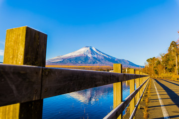 Fototapeta na wymiar Mount Fuji and Lake Yamanaka. The foreground is a wood fence.Photo taken in Yamanakako Yamanashi Prefecture Japan.
