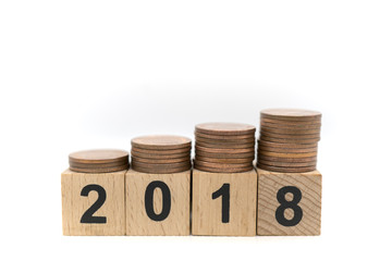 Miniature toy: wood block with 2018 and stack of coins on top of it , business ,financial, Success, Business Growth concept.