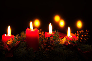 Christmas wreath with burning red candles, advent time