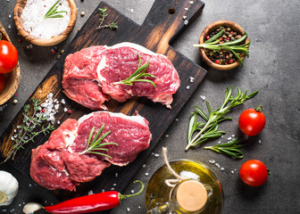 Raw beef steak with herbs.