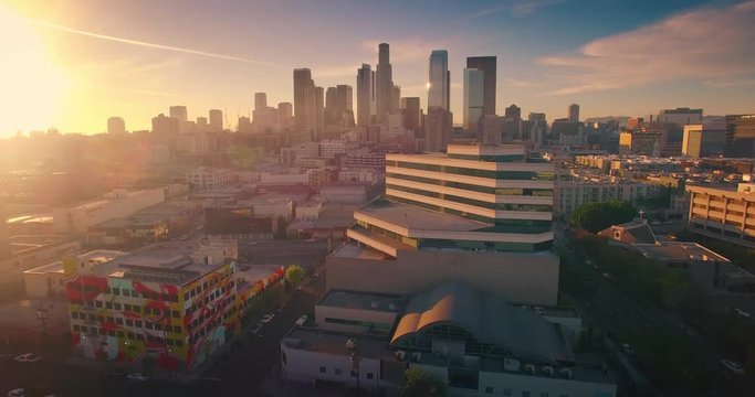 Aerial view city Los Angeles downtown skyline sunset Camera flying forward 4K