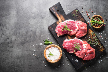 Fototapeta na wymiar Raw beef steak with herbs.