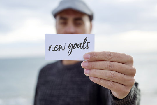 Man Shows Signboard With The Text New Goals