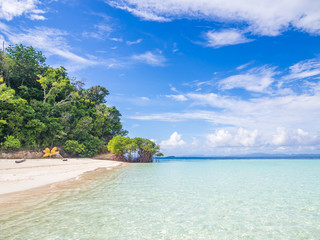 Landscape of cloudy day, clear blue sea, clean sandy beach and forest.