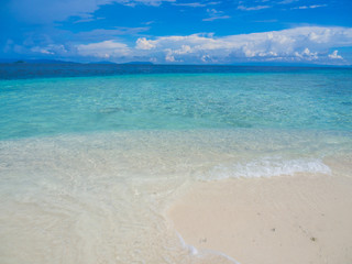 Abstract nature background, blue sky, white clouds, clear shading turquoise sea and clean sandy beach.