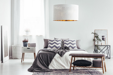 Patterned cushions in bright bedroom