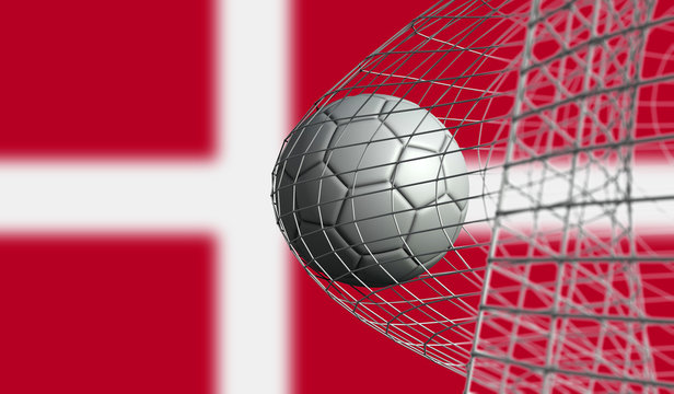 Soccer ball scores a goal in a net against Denmark flag. 3D Rendering