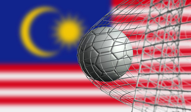 Soccer ball scores a goal in a net against Malaysia flag. 3D Rendering