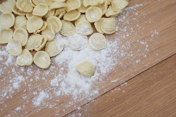 Fototapeta na wymiar Fresh orecchiette. Italian traditional pasta on wooden table with flour