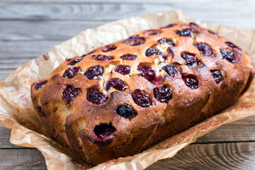 Homemade cake with cherries on a wooden table
