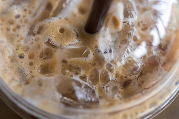 Fototapeta na wymiar Iced cappuccino close up with foam in glass