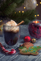 Christmas composition with thermo glass cup of tasty coffee topped with frothy milk and cinnamon powder served on rustic wooden table with xmas decoration 5
