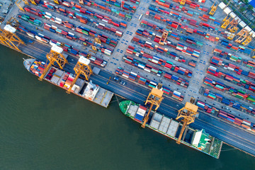 Containers yard in port congestion with ship vessels are loading and discharging operations of the...